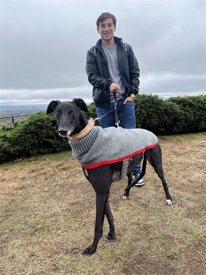 Chris with his greyhound in a sweater